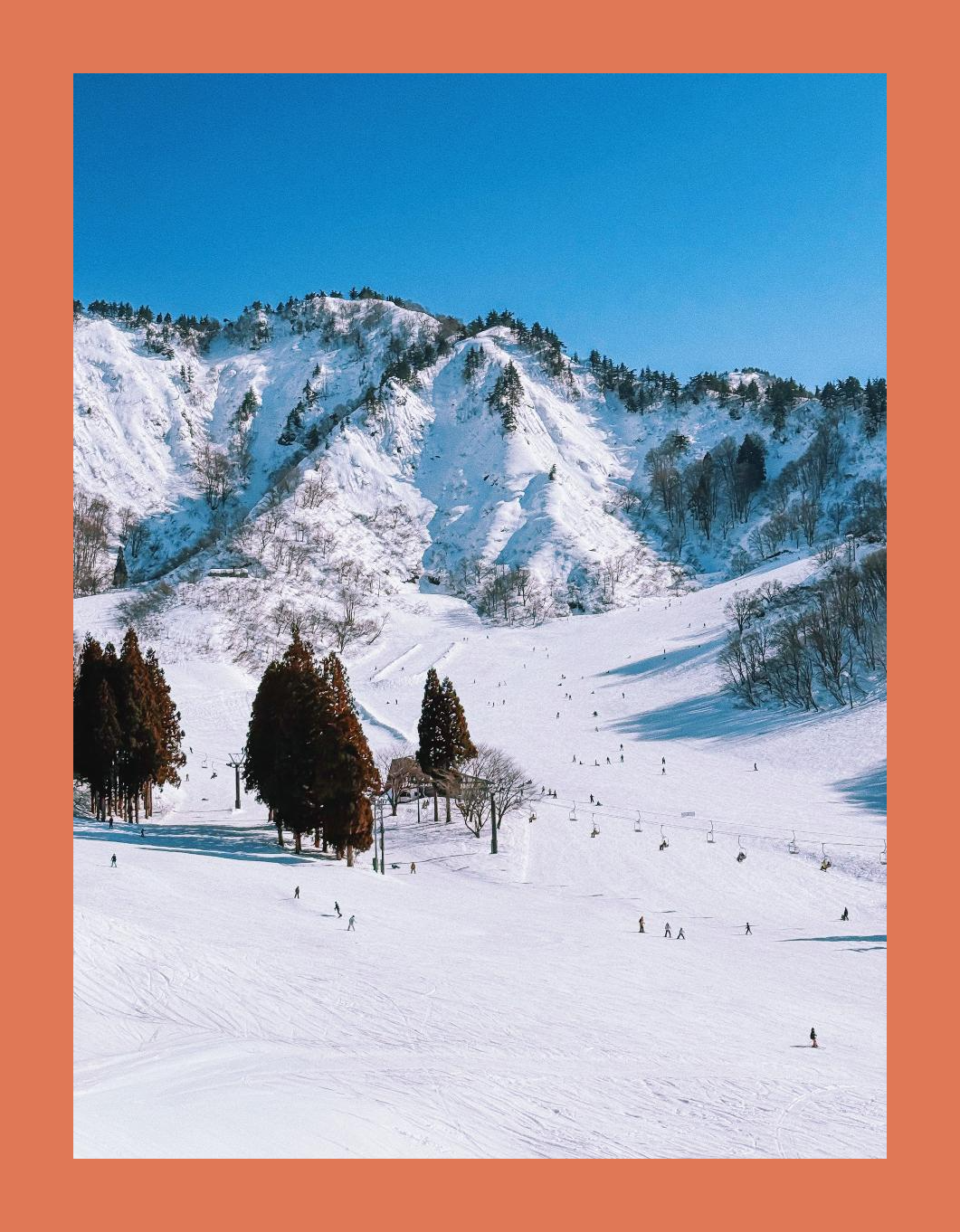 Photo of a mountain against a blue sky with a terracotta border, exported from Borderz